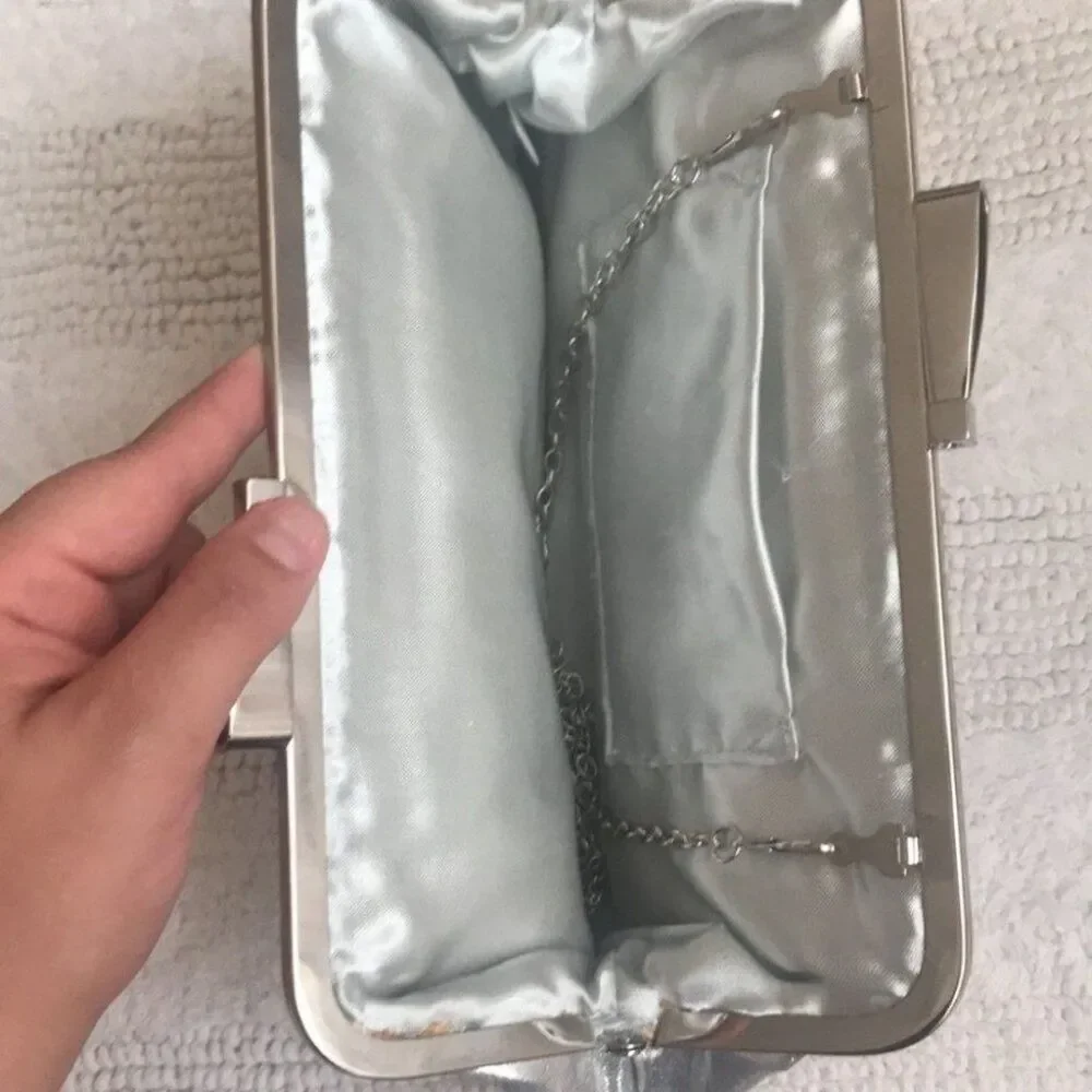 Stunning silver satin like clutch, metallic bow